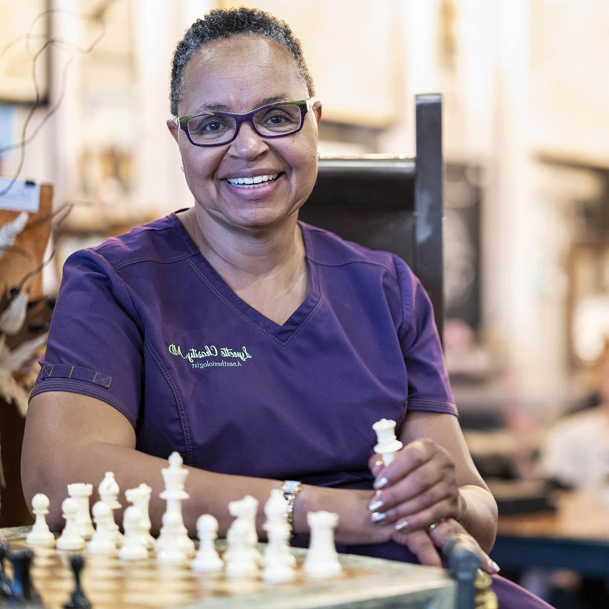 Portrait of Chatham alumna Lynette Charity in nurse scrubs